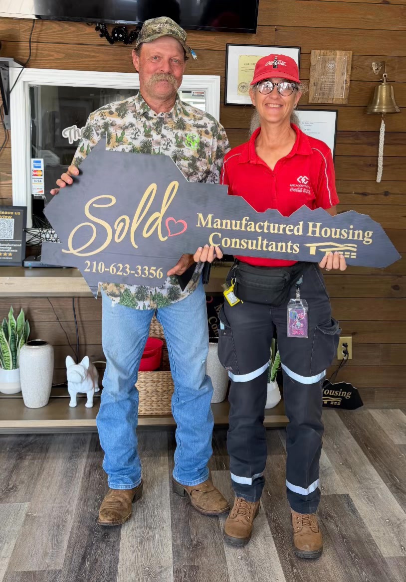 Gina and Bruce Wilkins holding an MHC sold key on closing day